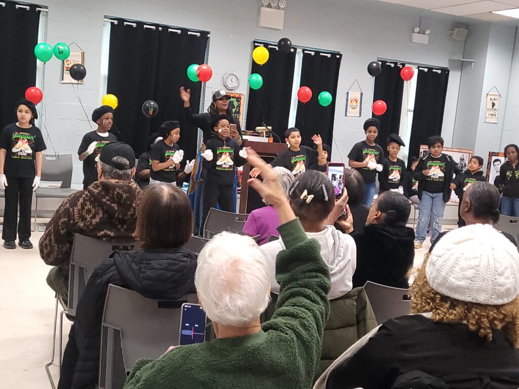 The students of the Jack August Program dancing and singing with the audience joining in