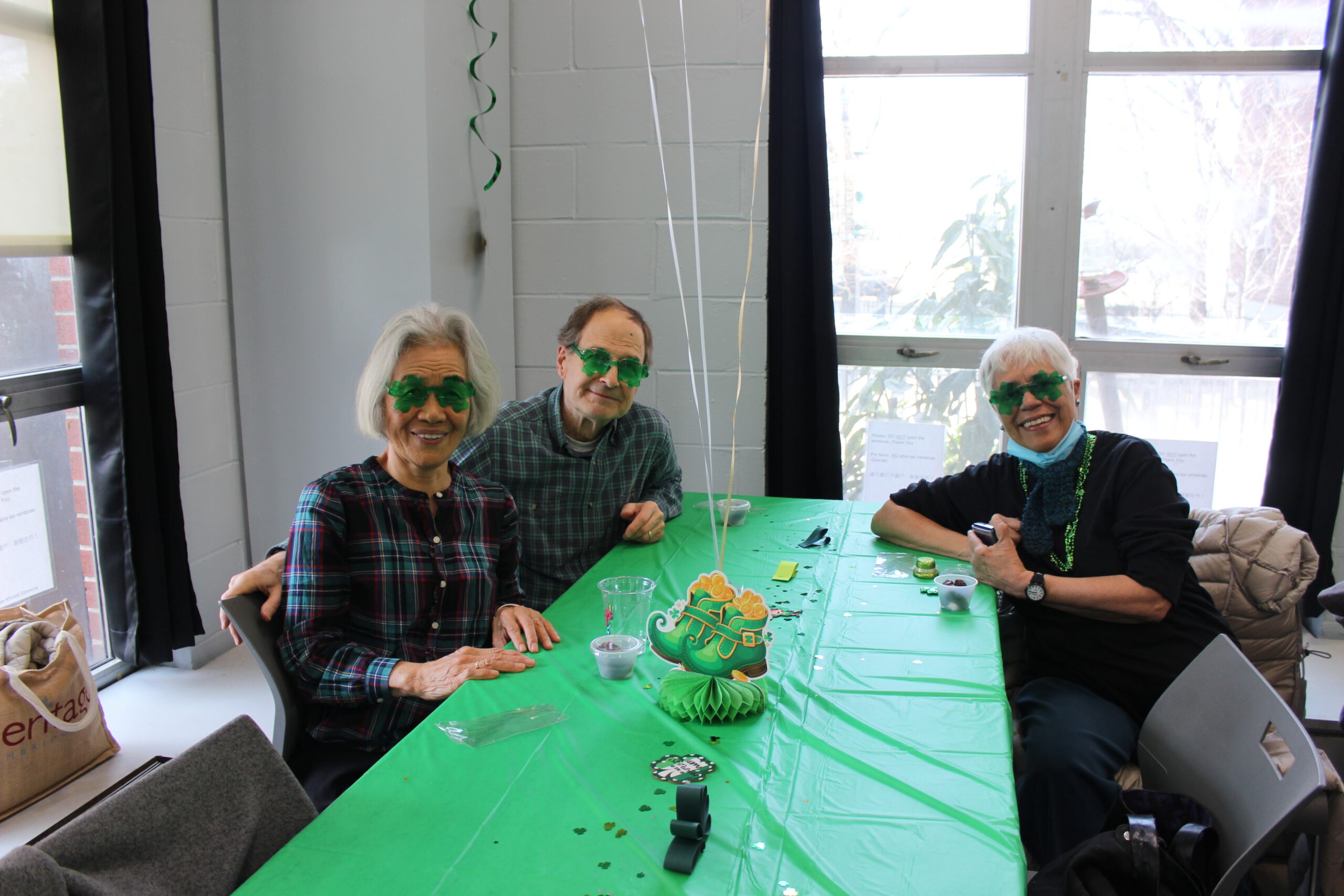 Older adults sitting around a table themed for Saint Patrick's Day