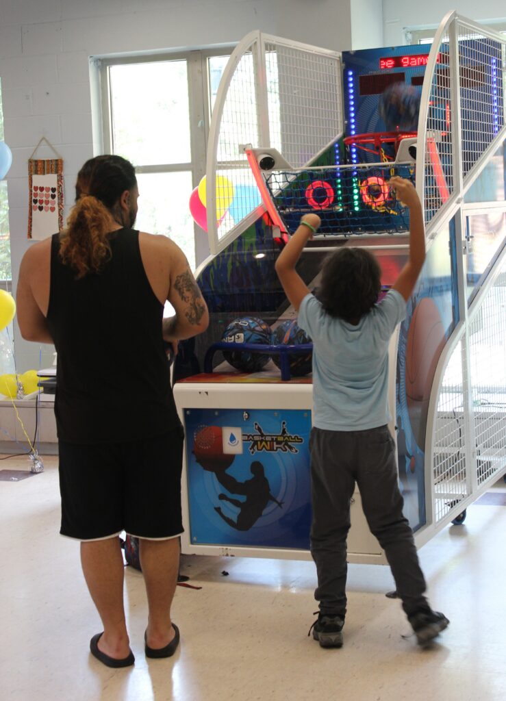Child and adult enjoying the arcade game